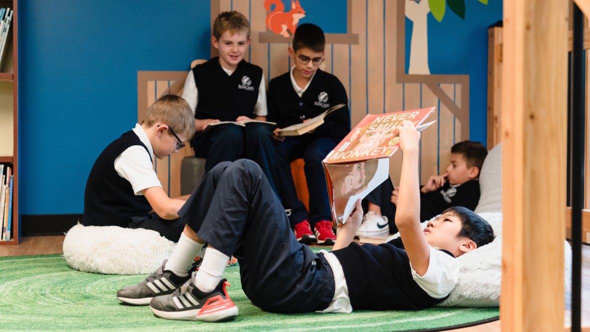child reading on his back in a library