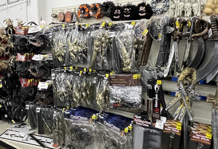 A display of plastic swords and other costume accessories