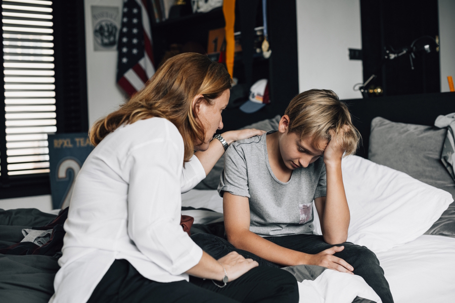 Mom and a son in his room, mom comforting disappointed son