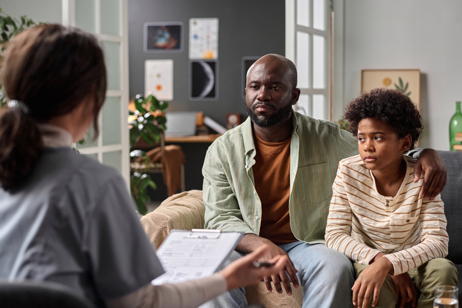 Dad and son talking with a counselor