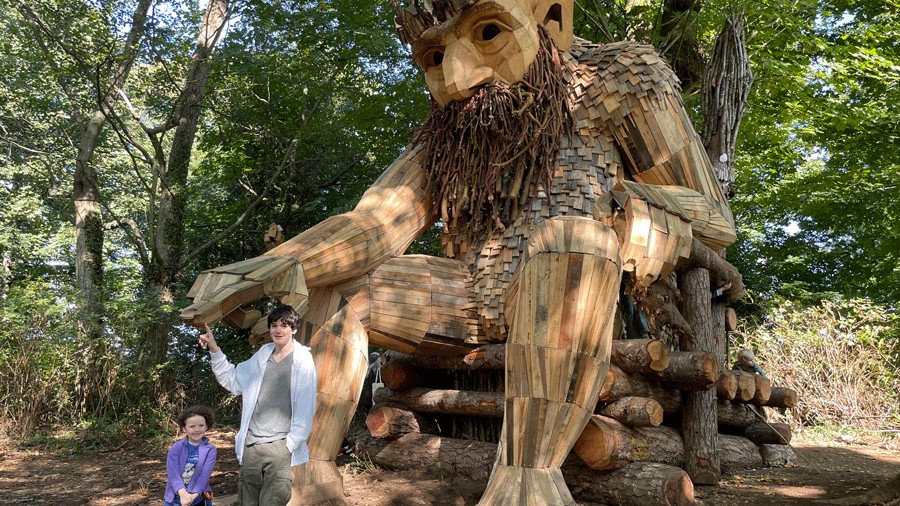 giant Thomas Dambo troll near Seattle with kids posing in front of it