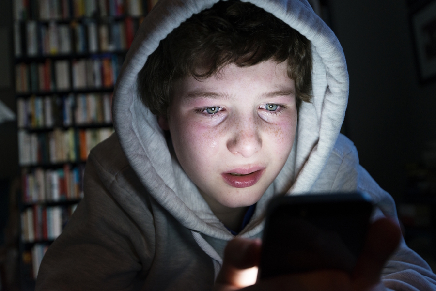 boy upset looking at a phone
