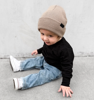 little boy wearing a mushroom knit hat