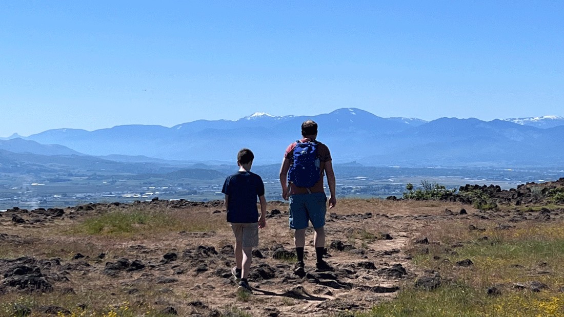 family hiking Upper Table Rock on a family vacation in Southern Oregon