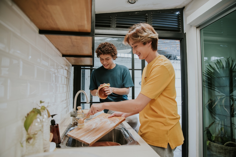 two teen boys washing the dishes