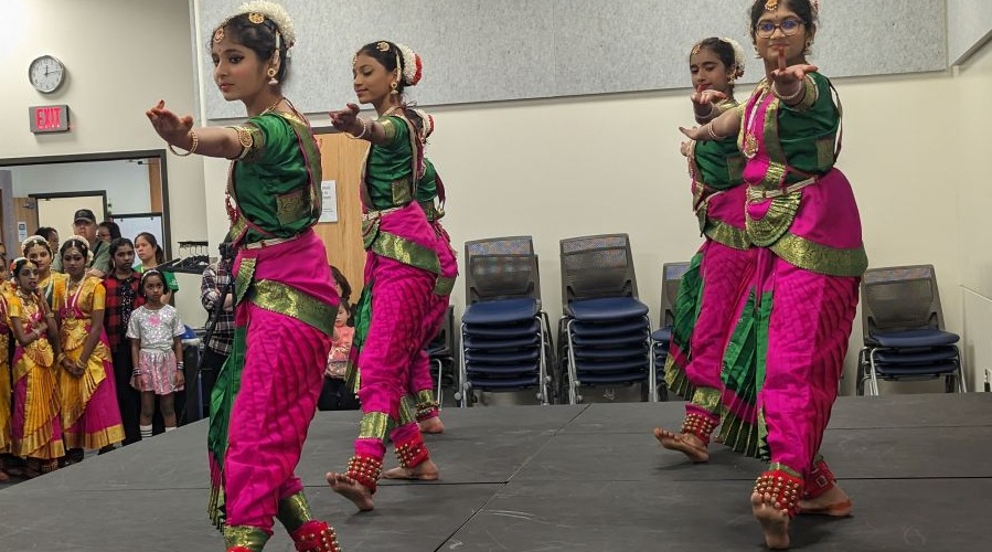 Brightly clad dancers perform for AAPI Month.