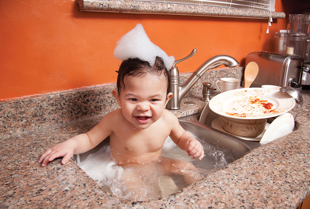 baby being washed in sink