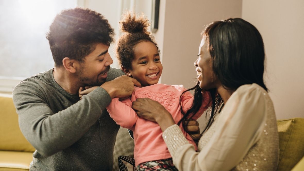 married couple and child in living room