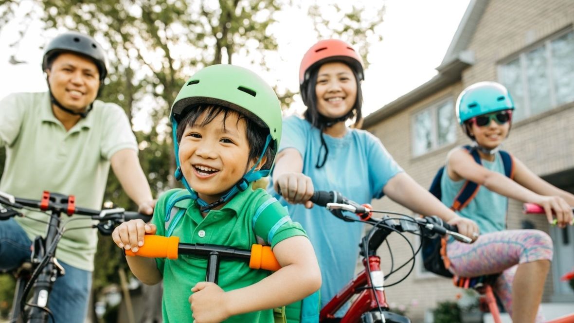 family biking outside in summers