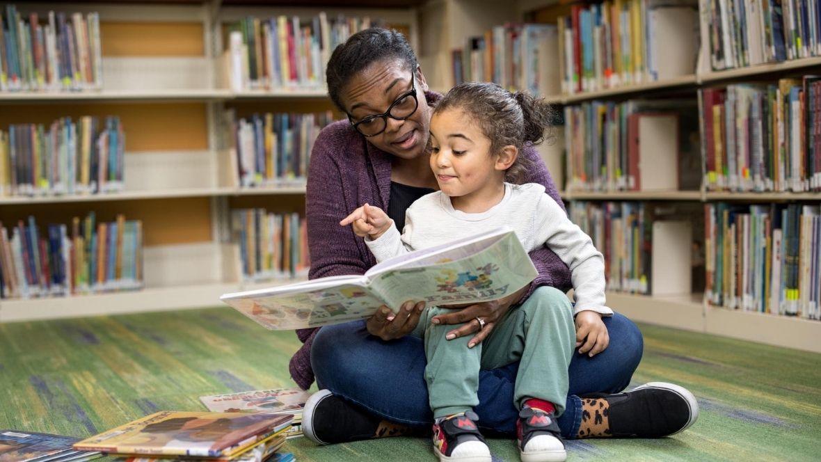 parent and child reading at library