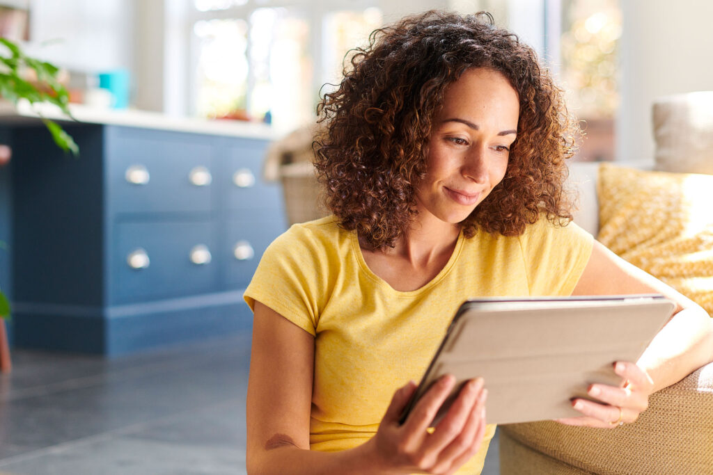 Woman watching a webinar on an iPad, credit iStock photo