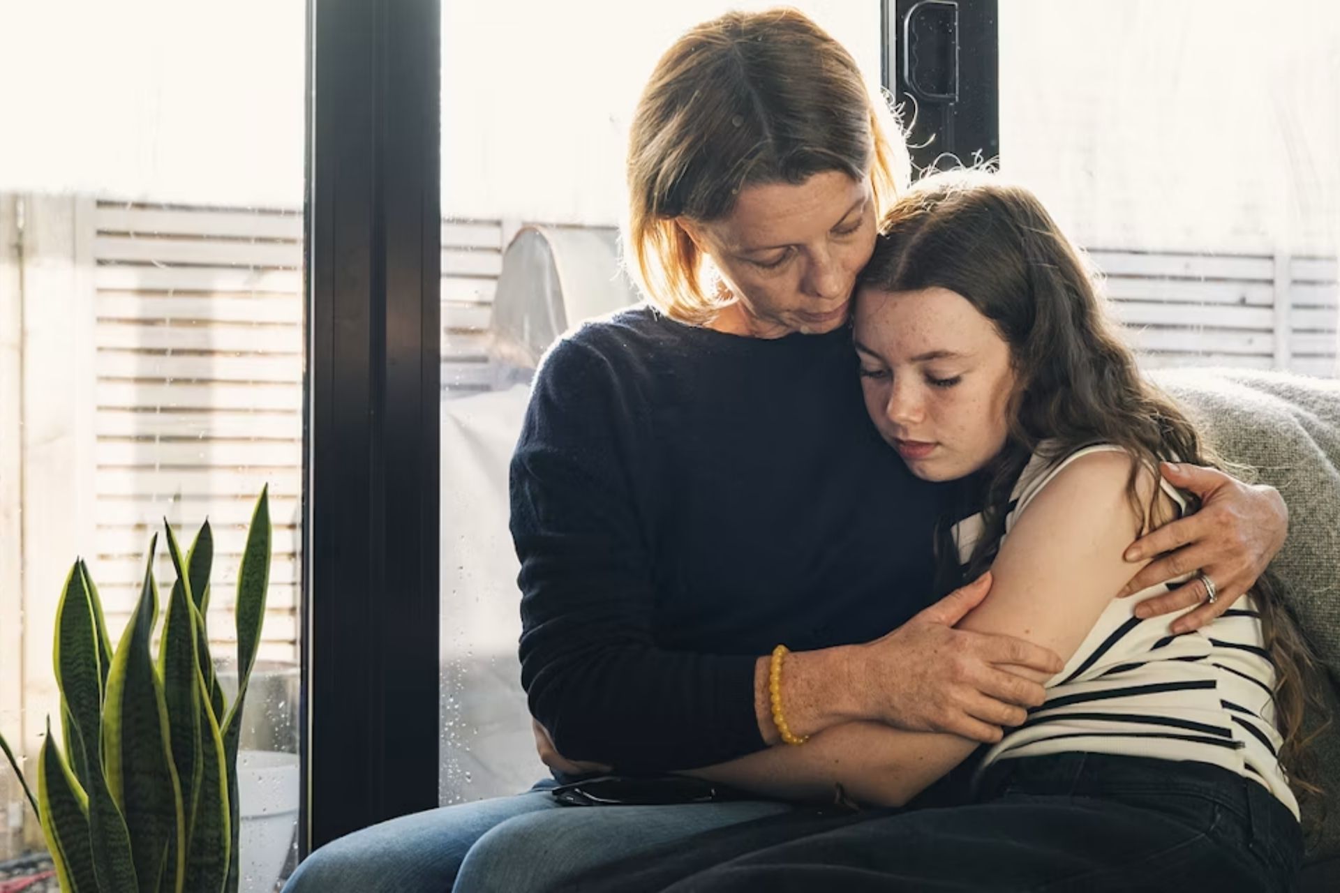 mother holding her scared daughter