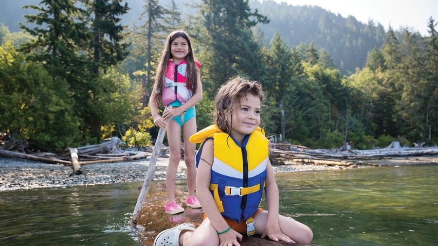 two girls kayaking in a slow river