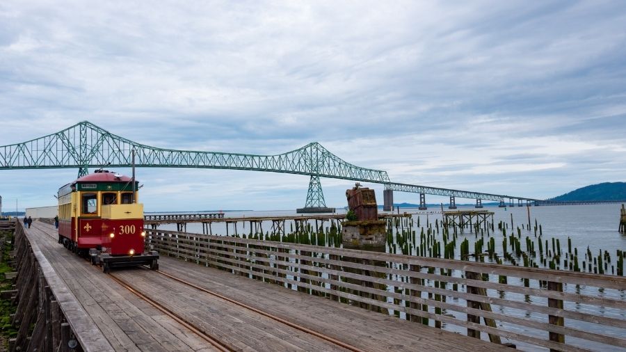 Astoria Riverfront Trolley passing under the Astoria-Megler Bridge