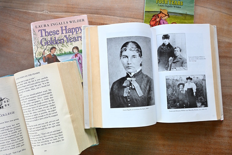 Books by Laura Ingalls Wilder and an image of her and her husband