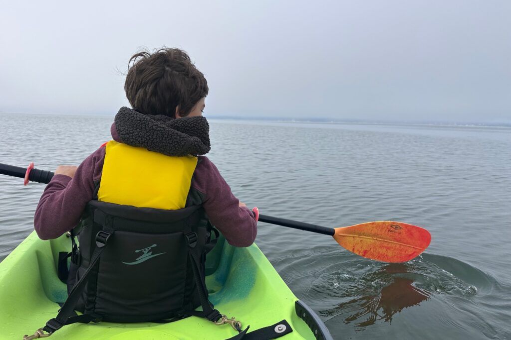 Kid kayaking on the water in the early morning during a Camano Island getaway