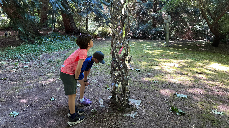 Kids examining the artwork at Metzke Sculpture Park, a Camano Island attraction for families