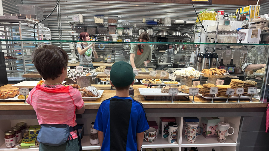 Kids looking at a bakery display case at The Commons Marketplace on Camano Island