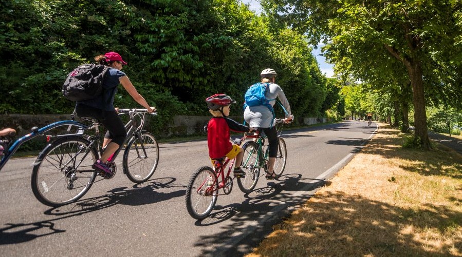 A family rides bikes along a car-free path around Lake Washington.