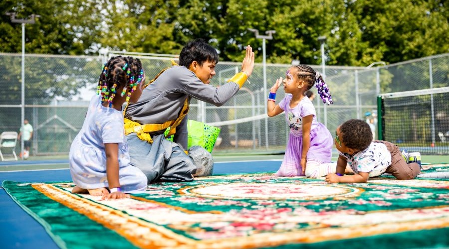 Kids and performers connect after a cultural performance.