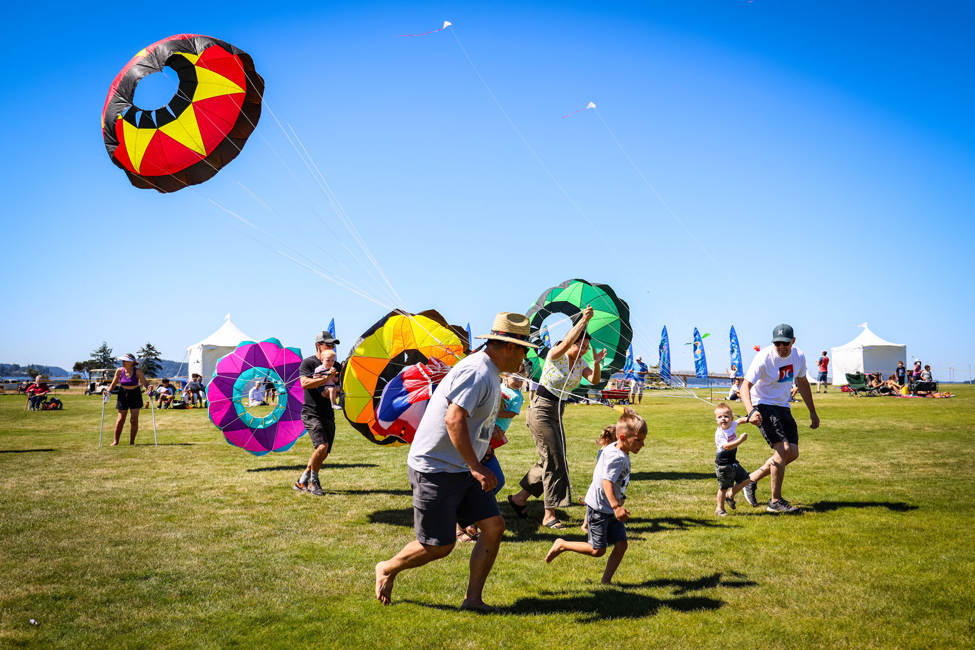 parent and child running with kites during the Kite Festival, a weekend event for Seattle-area families