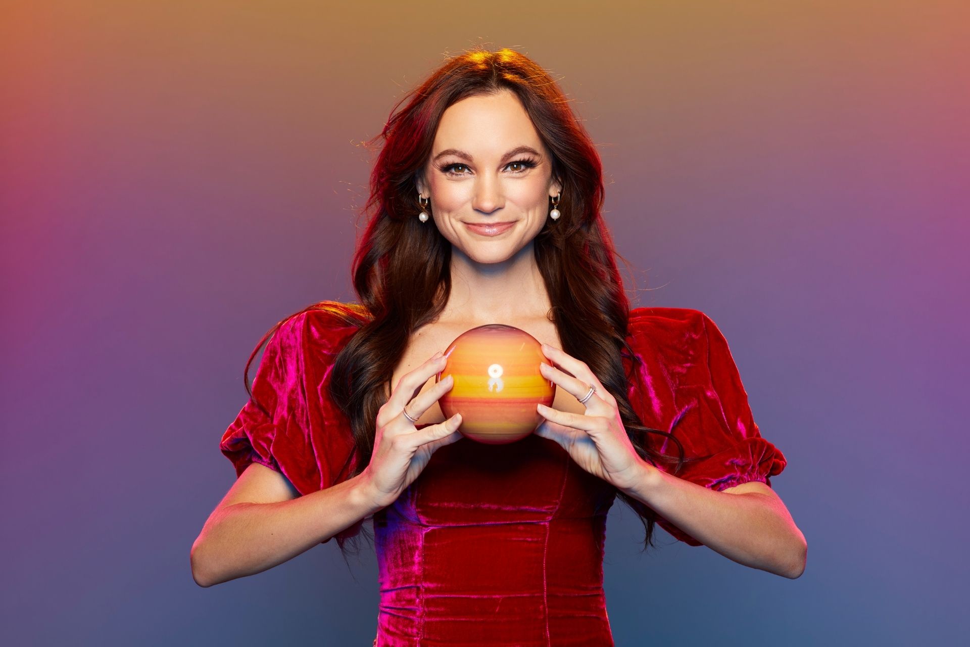 emily the space girl holding a planet prop in her hands