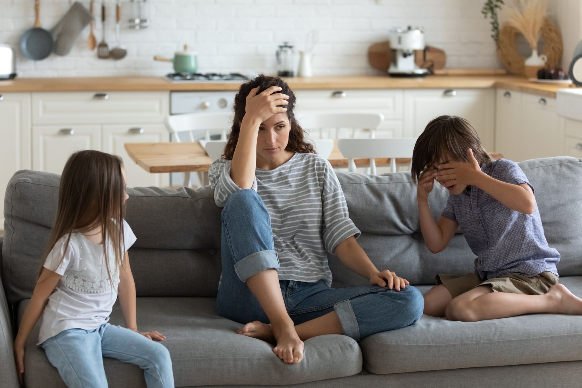 mom about to lose it with two kids on couch