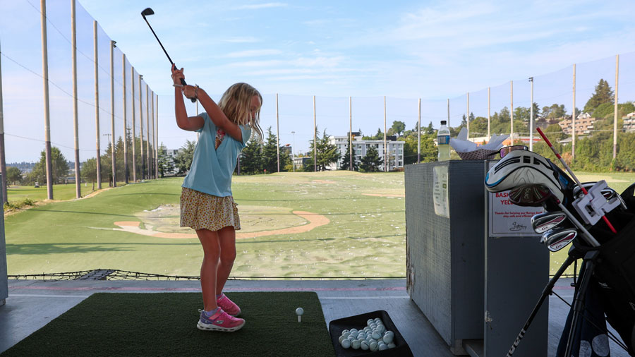 girl practicing her golf swing