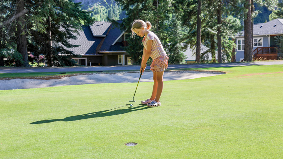 girl practicing golfing on an outdoor course near Seattle