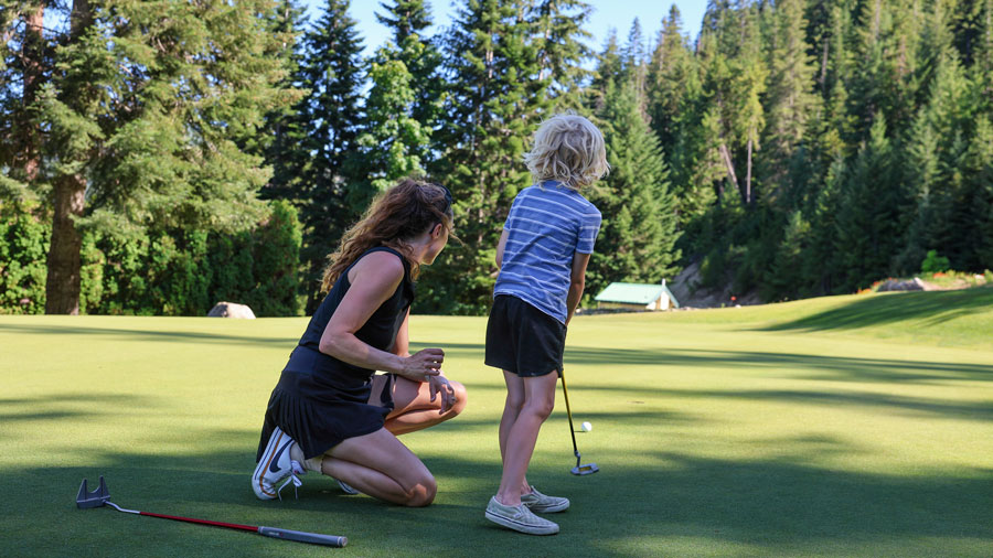 mom and son on outdoor Seattle golf course learning how to play