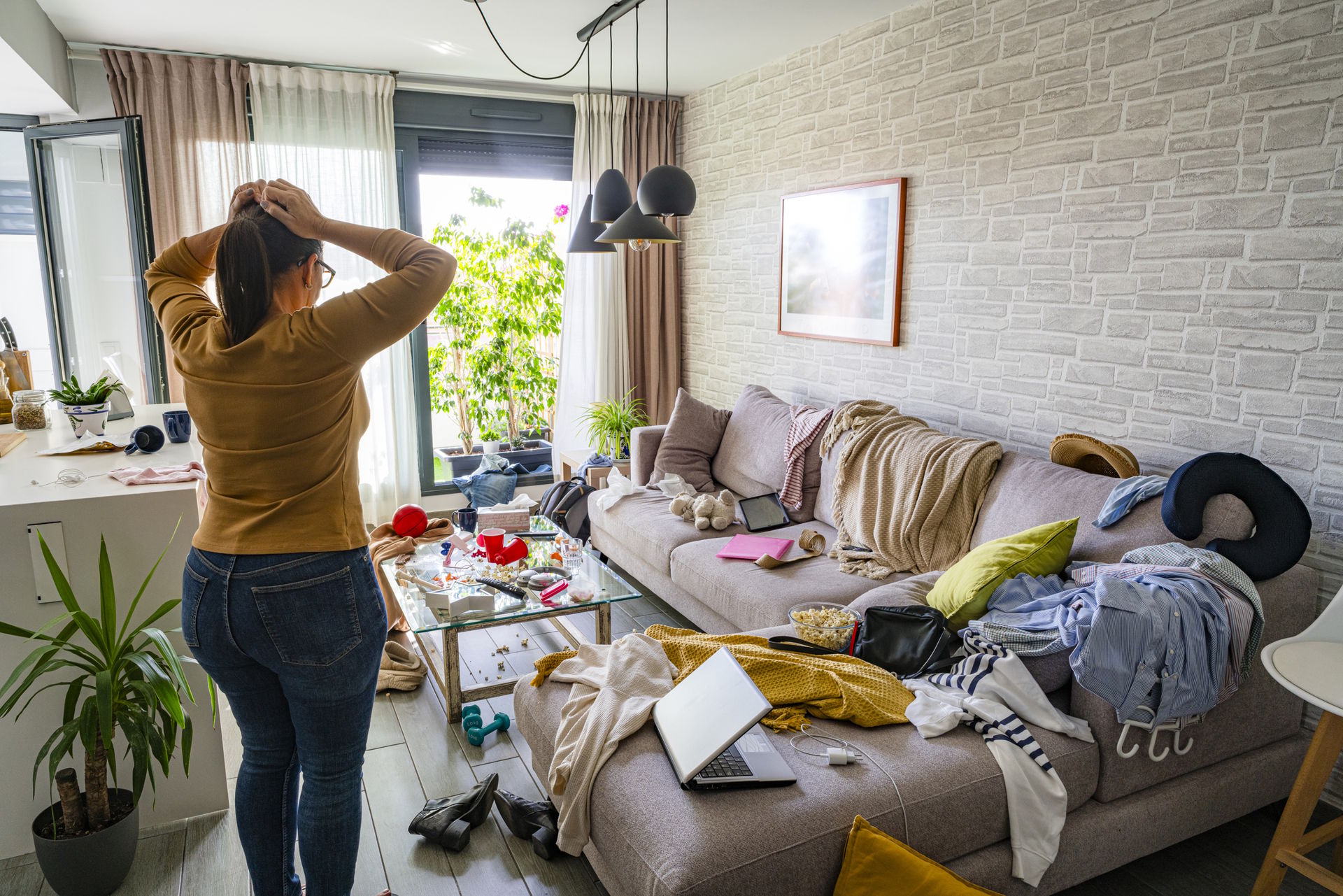 A woman looks at her home needing clutter organization for her family