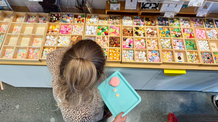 child picking charms for a Decoden art project at Robot vs Sloth