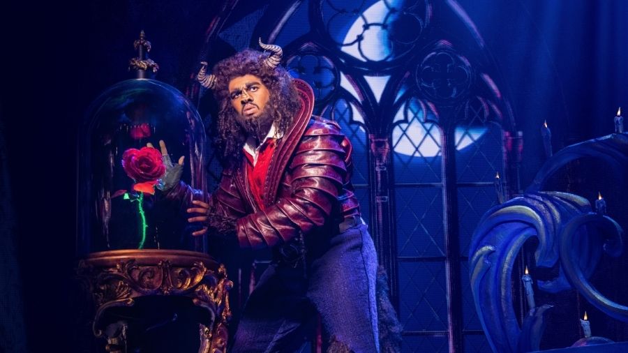 actor playing 'beast' in the show with a bell jar with a rose inside