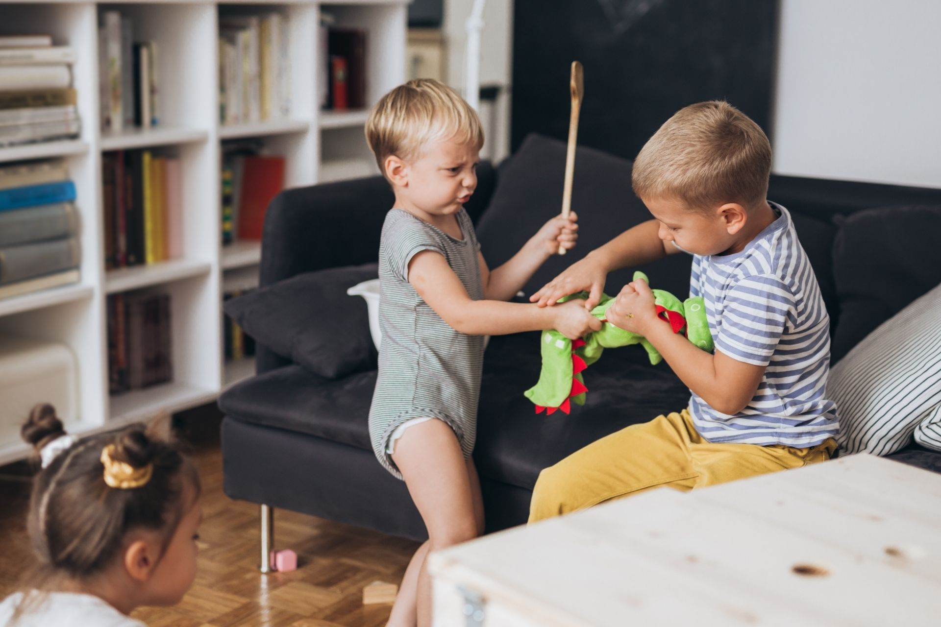 two small boys squabbling over toys