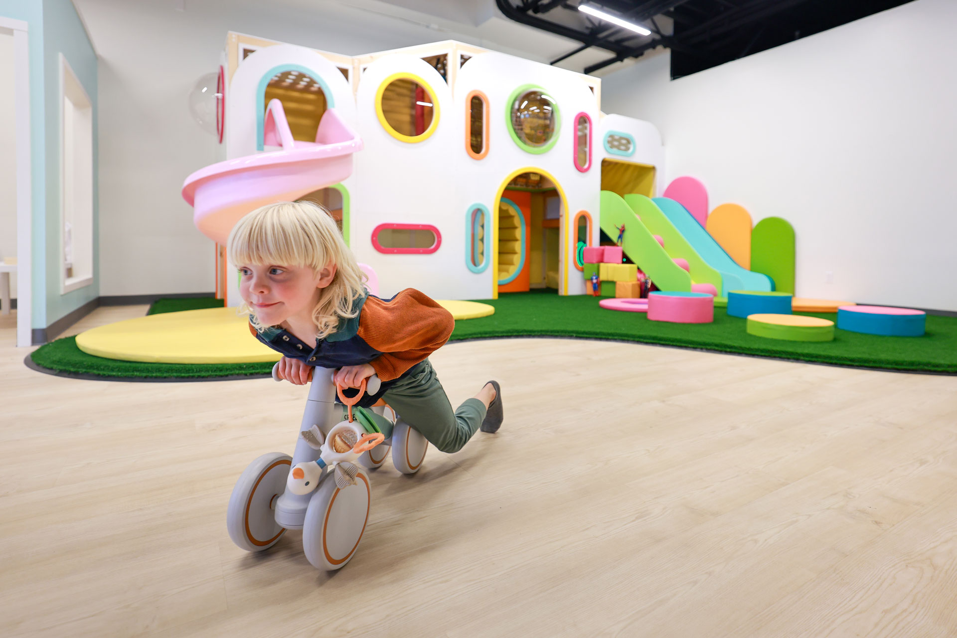 kid on balance bike playing in a new indoor play cafe near seattle, Bright Bean Play Cafe