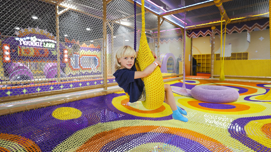 kid swinging on a crochet swing at Twinkle Land Play Cafe