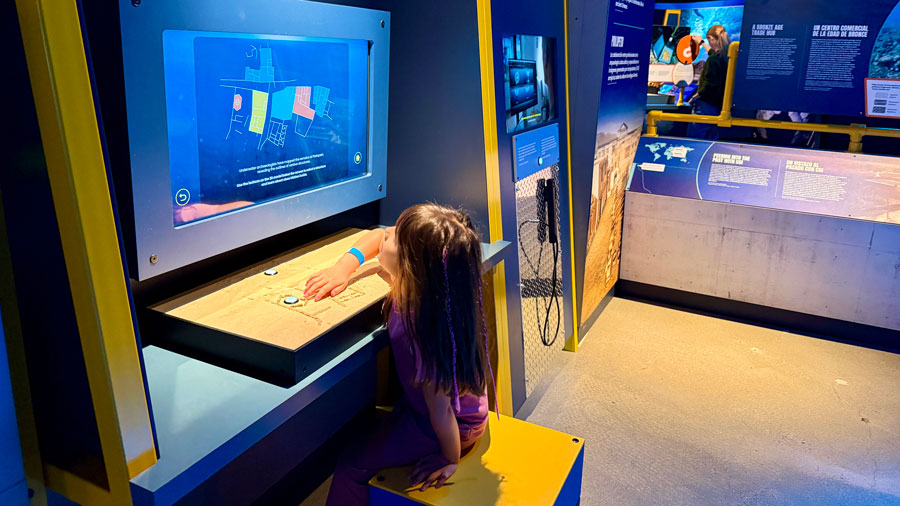Child interacting with the Pavlopetri exhibit at PacSci in Seattle 