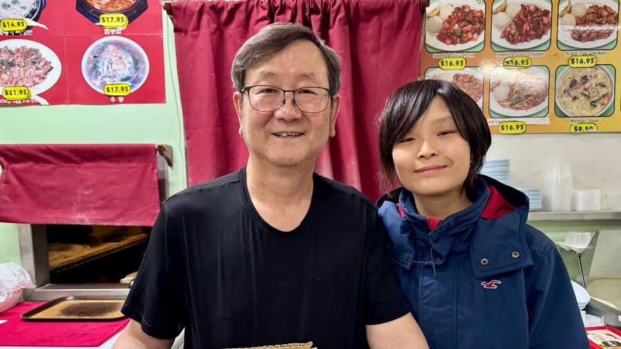 two people smiling behind the counter at peking garden restaurant in tacoma, a unique tacoma restaurant that welcomes families