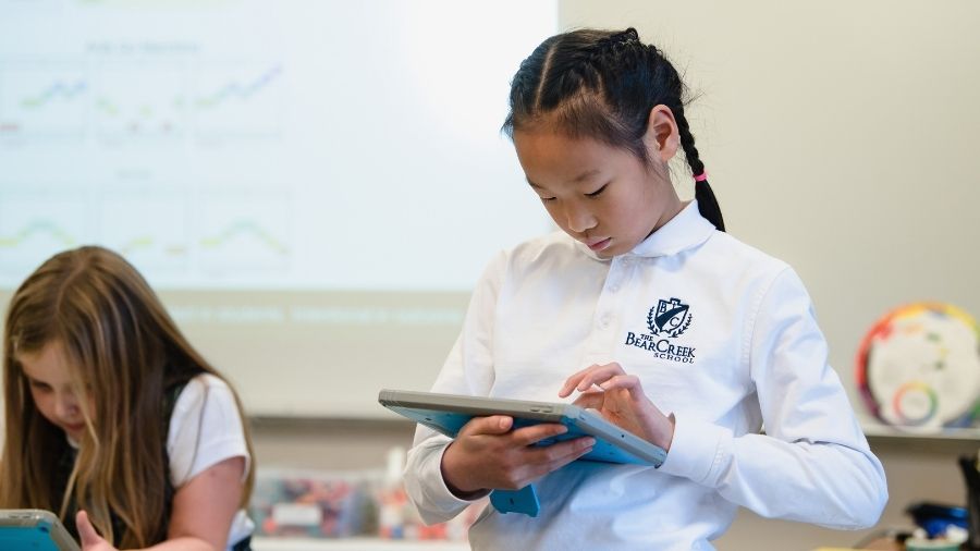 school student using ipad in classroom